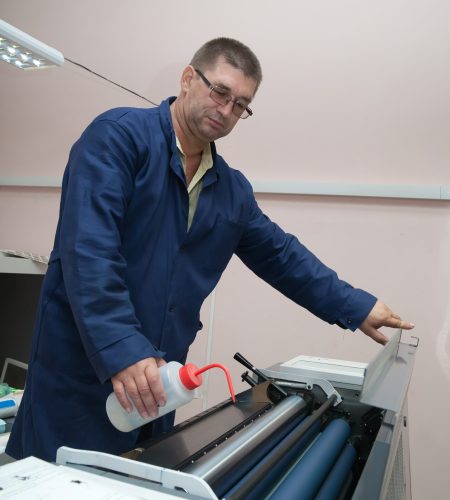 Printer working at his modern offset machine